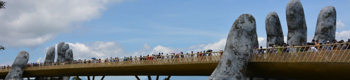 Bridge of people held in giant hands